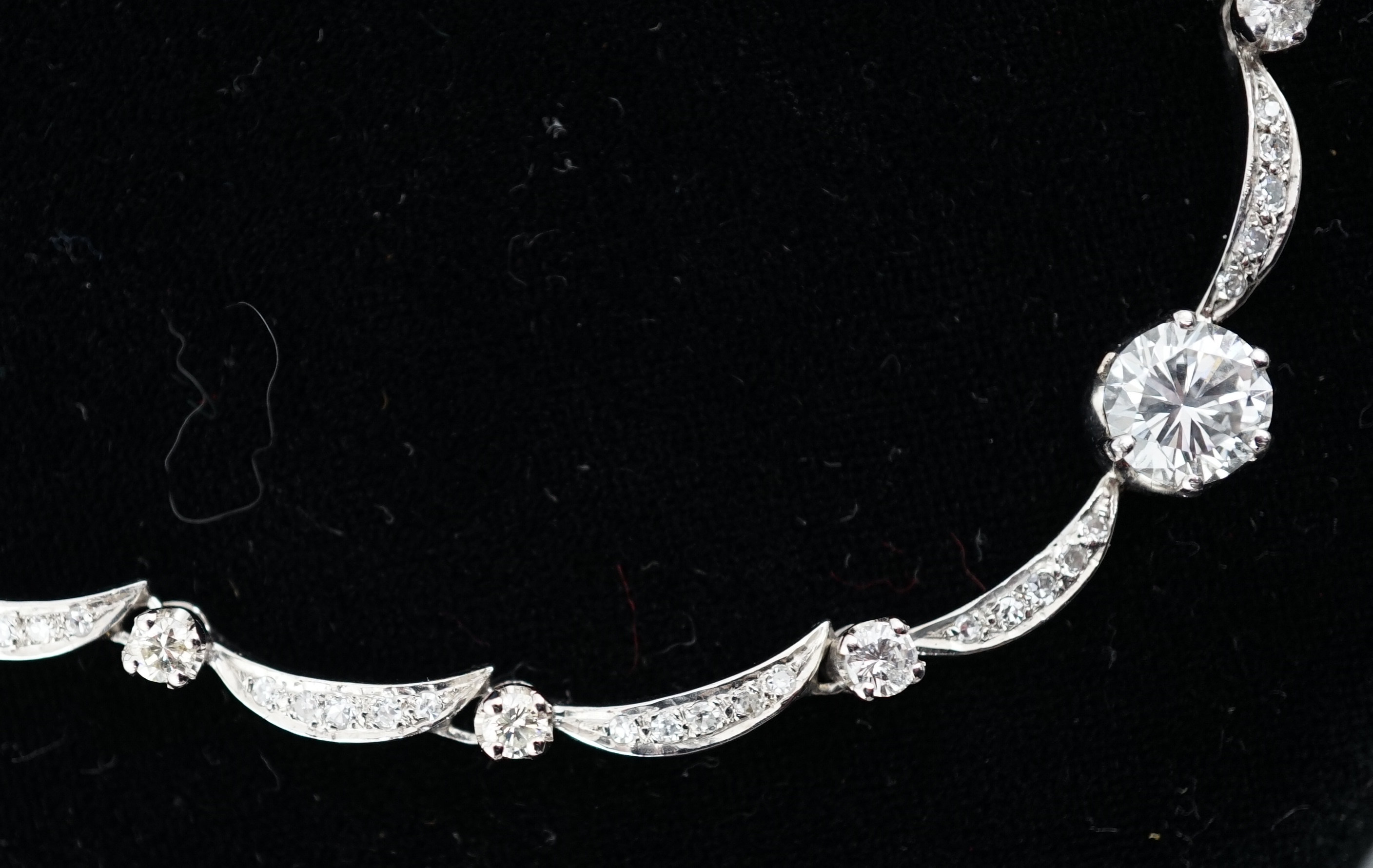A modern 18ct white gold and diamond cluster set necklace